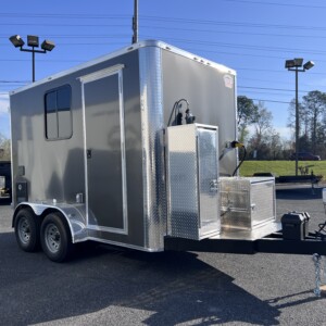 Charcoal Legacy Series 7x12 mobile pet grooming trailer with Flying Pig tub, K9 II dryer, electric grooming table, solar package, Boss stereo system, and generator power.