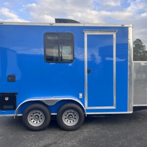 Blue Legacy Series 7x12 mobile pet grooming trailer with Flying Pig tub, K9 II dryer, electric grooming table, solar package, and generator power.