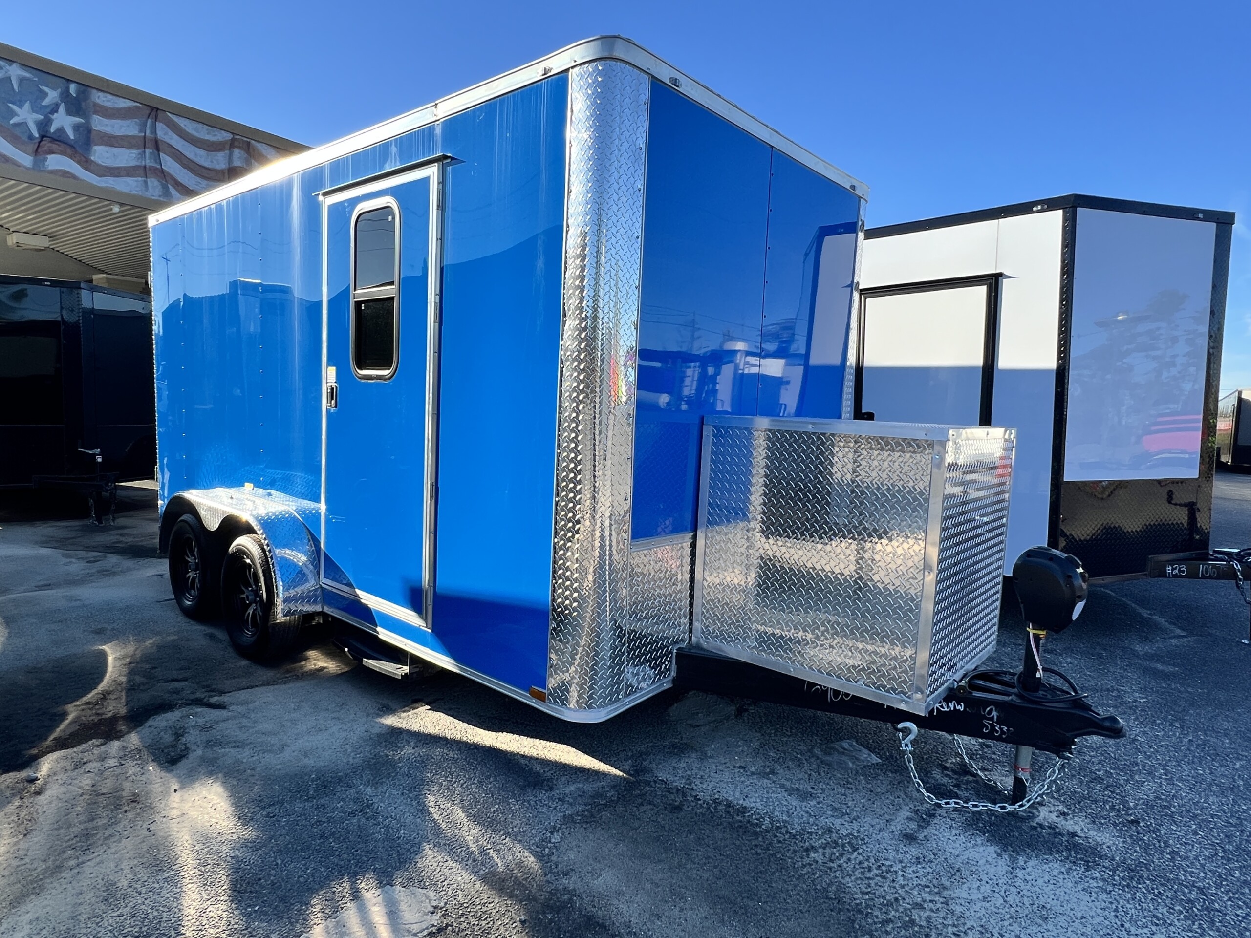 True Blue Genesis Series 7x14 mobile pet grooming trailer with Polycore exterior, Flying Pig tub, generator box, alloy wheels, and tandem axles.