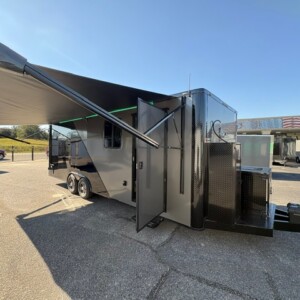 8.5x24 luxury mobile pet grooming trailer featuring dual grooming stations, private restroom, stainless steel kennels, electric awning, blackout package, and premium grooming equipment.