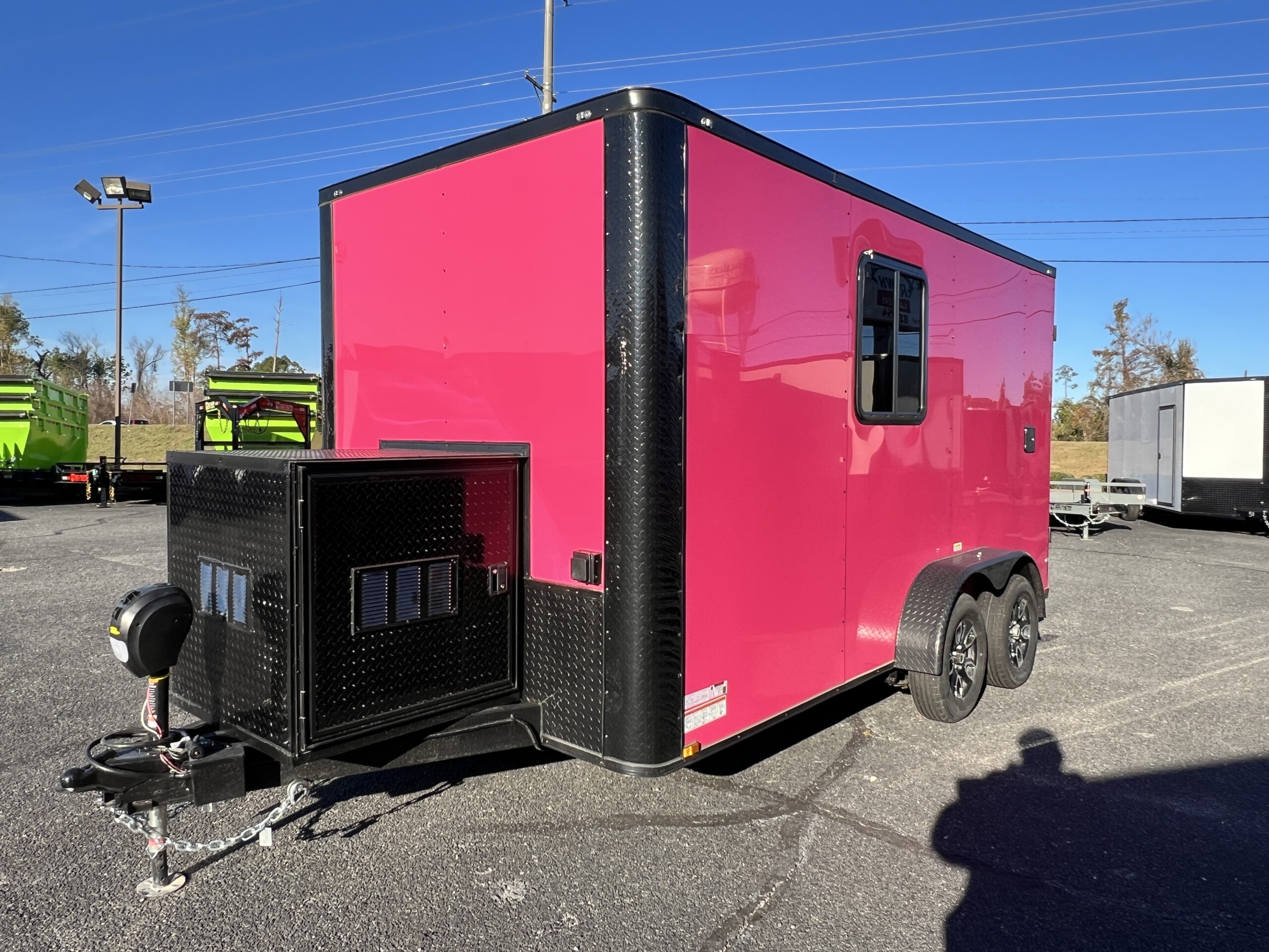 Pink Genesis Series 7x12 mobile pet grooming trailer with blackout trim, generator box, electric jack, mag wheels, and 75-gallon water tanks.