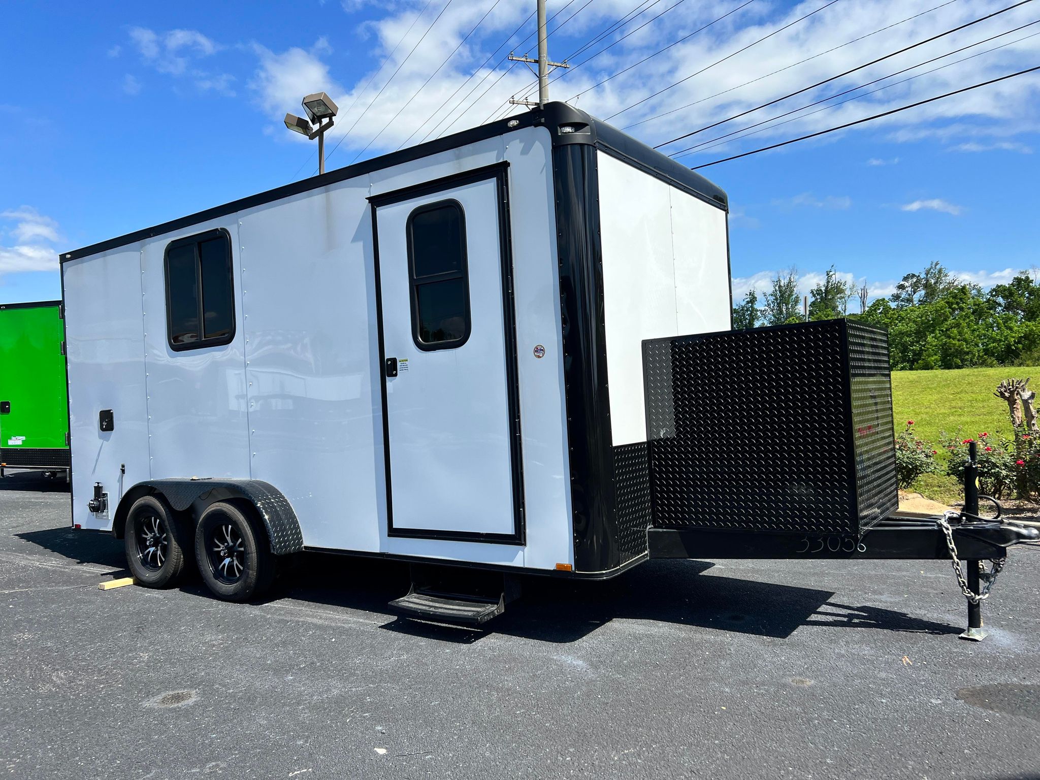 White 7x16 Quality Cargo pet grooming trailer with blackout package, Flying Pig tub, Hanvey HairVac, generator box, A/C, and water tanks.